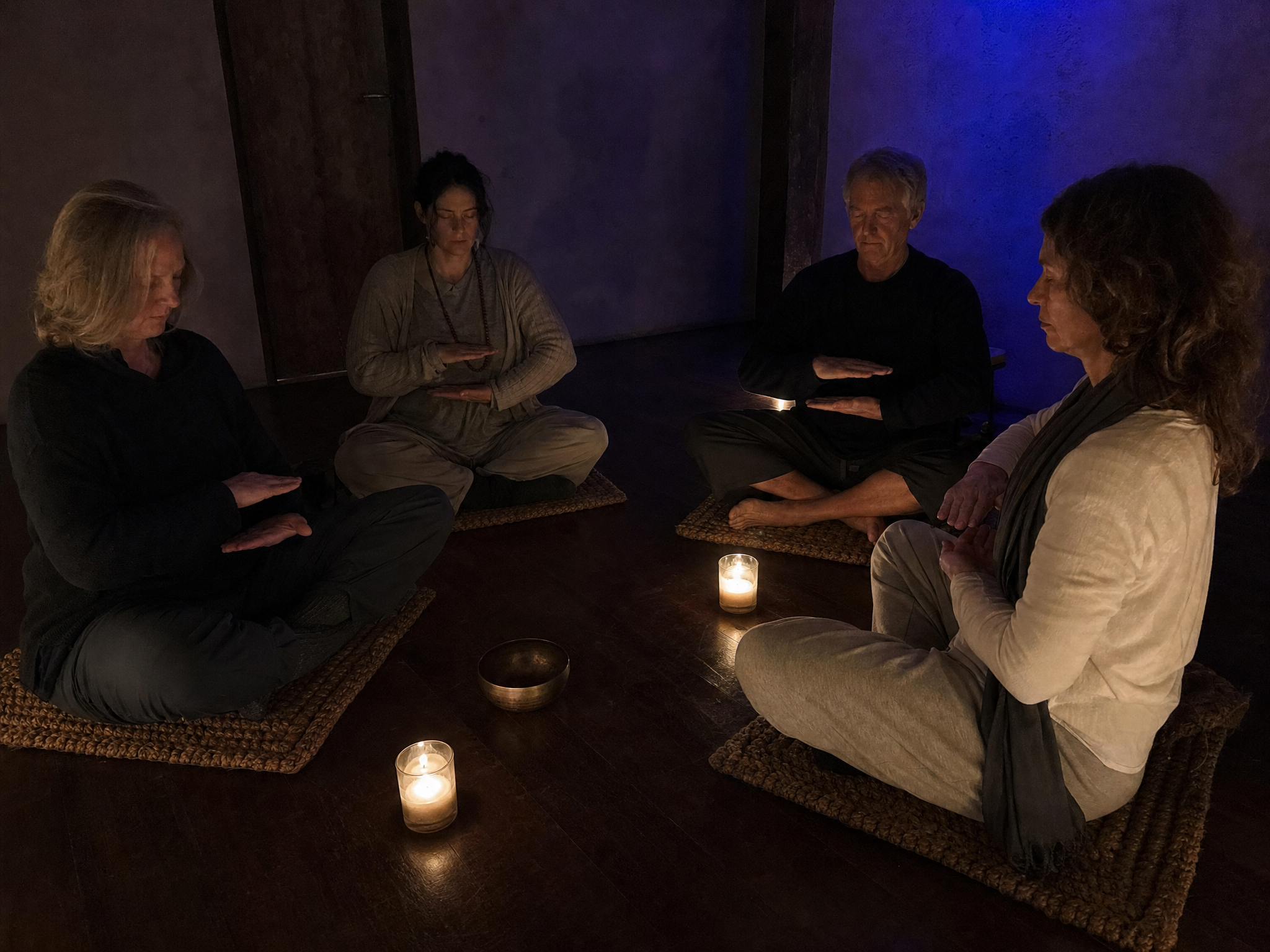 Small Counterplane Awakening practice circle in a candlelit room
